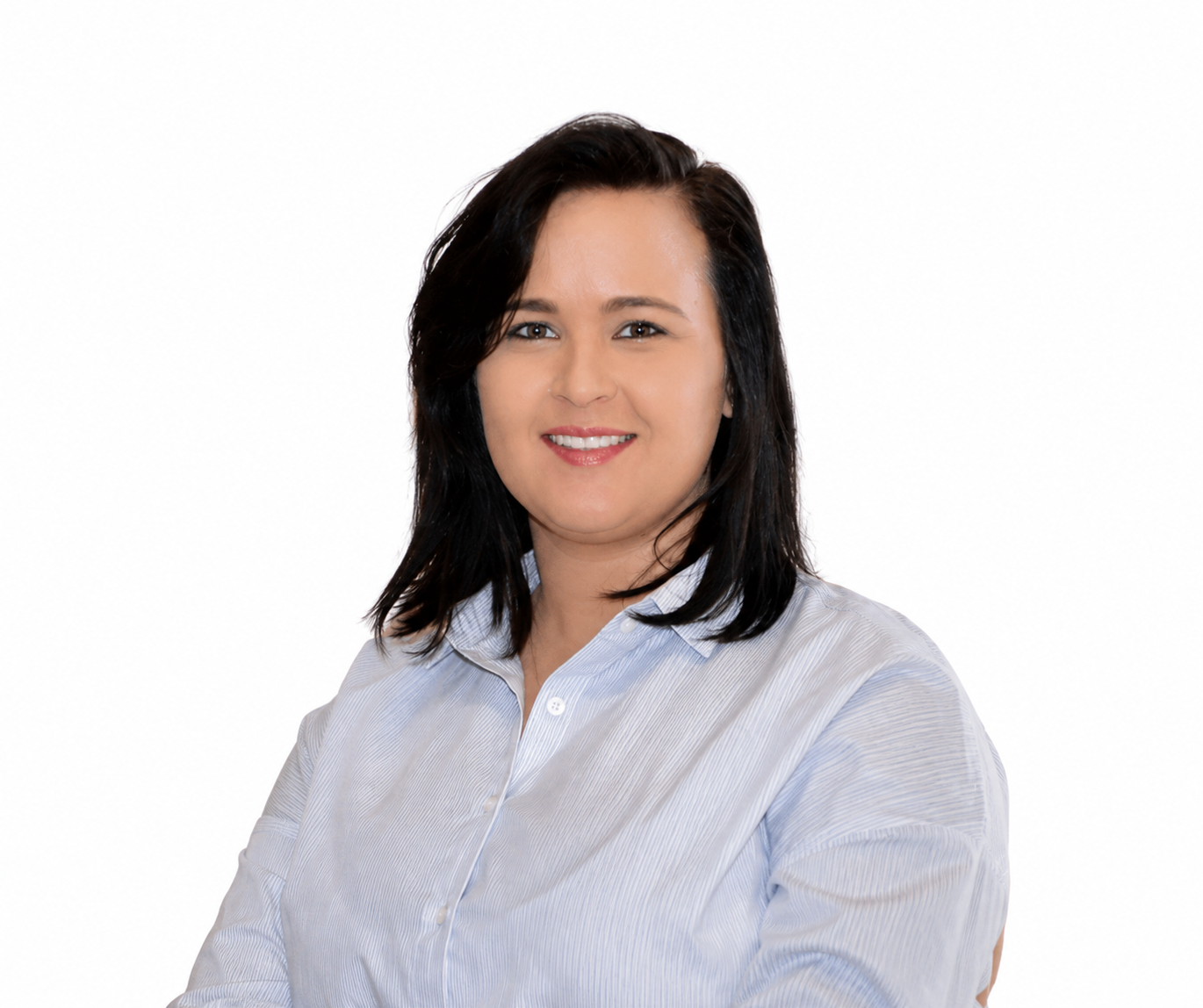Head-and-shoulders portrait of a smiling woman with dark hair in a light blue striped shirt, looking at the camera against a white background.